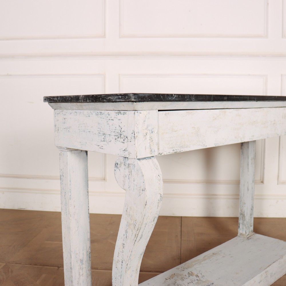 A French provincial painted wooden console table featuring a dark marble top and a lower display tier. View VIII