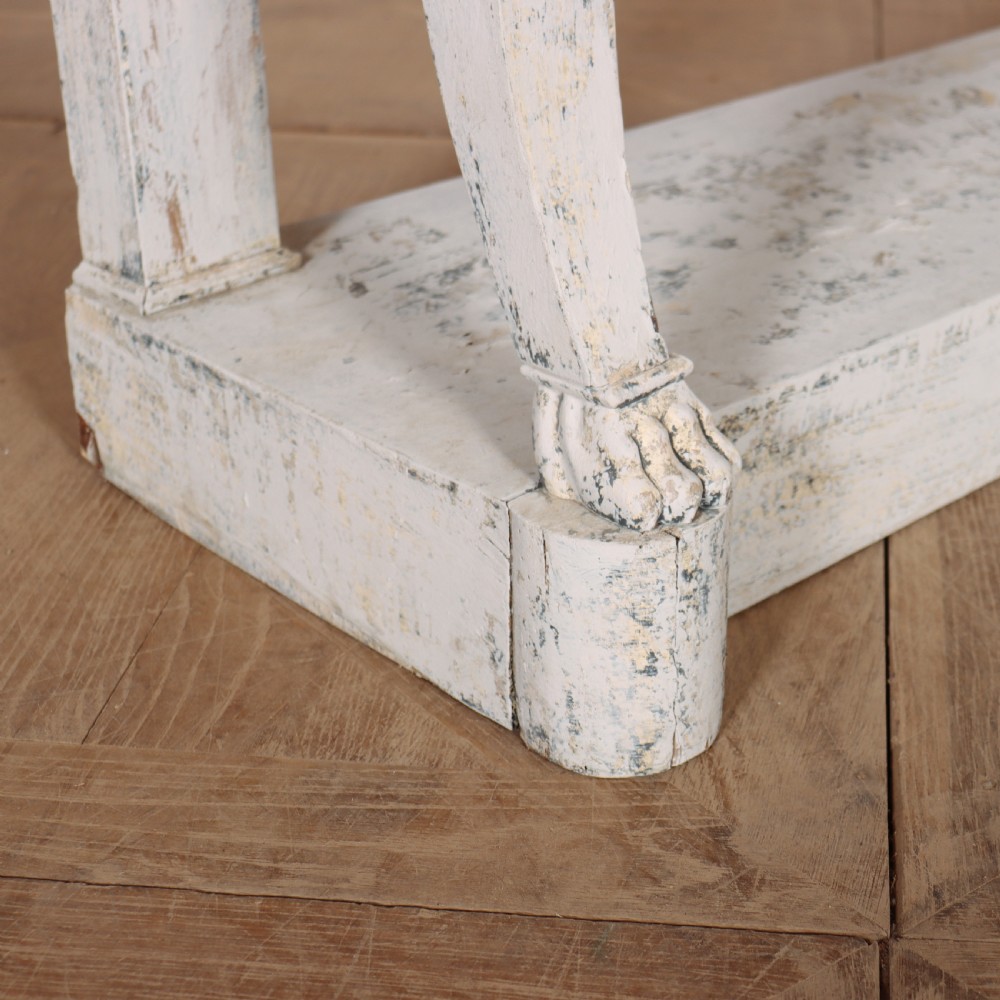 A French provincial painted wooden console table featuring a dark marble top and a lower display tier. View IX