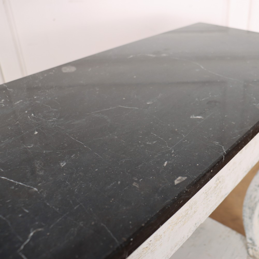 A French provincial painted wooden console table featuring a dark marble top and a lower display tier. View XII