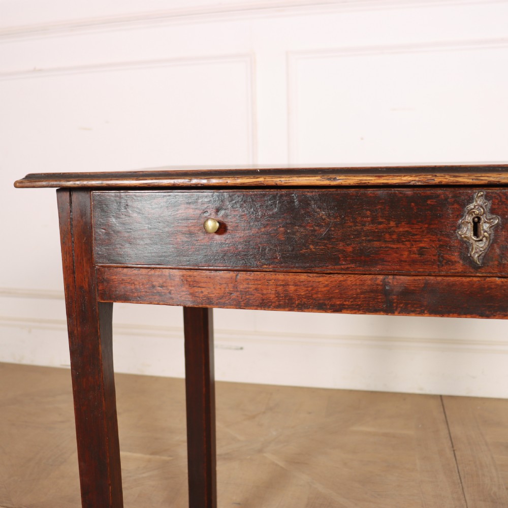 An antique dark oak lamp table featuring a single frieze drawer with brass knobs and a decorative keyhole escutcheon. View II