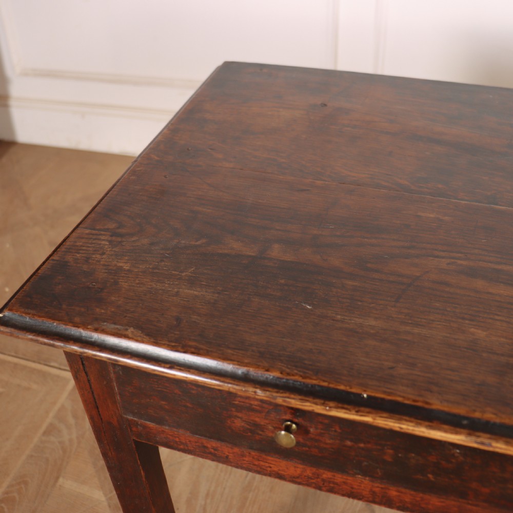 An antique dark oak lamp table featuring a single frieze drawer with brass knobs and a decorative keyhole escutcheon. View IV