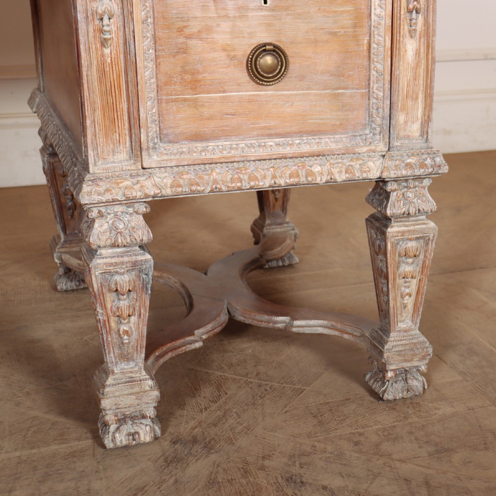 A pale bleached oak kneehole writing desk with intricate carved legs, five drawers with brass drop handles, and double X-frame stretchers. View IX