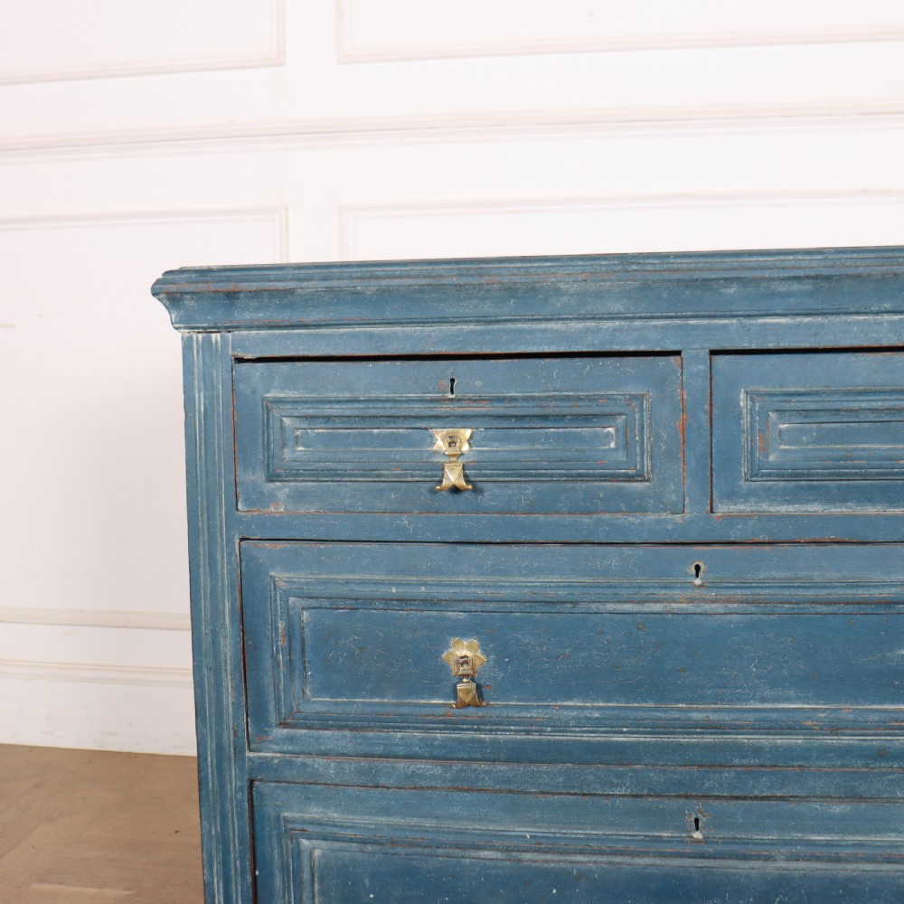 A Danish painted blue wooden commode featuring three drawers with brass handles and moulded panel details. View VI