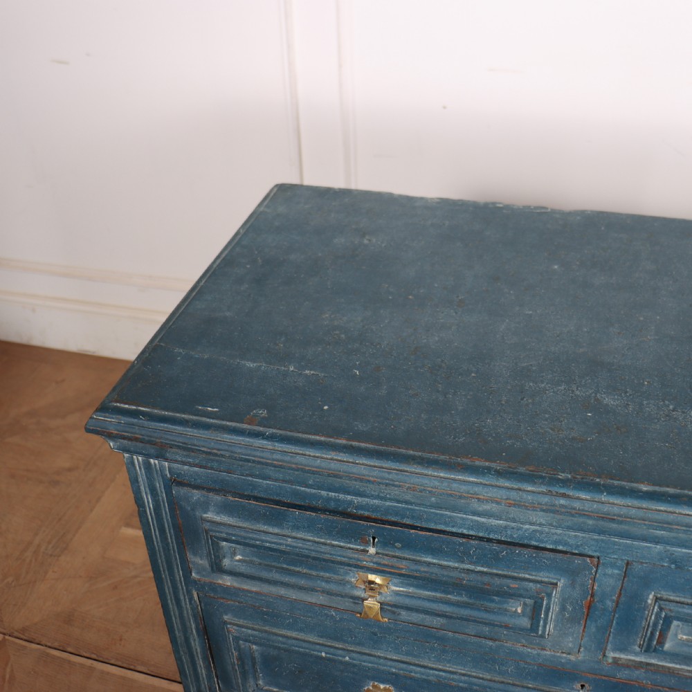 A Danish painted blue wooden commode featuring three drawers with brass handles and moulded panel details. View VIII
