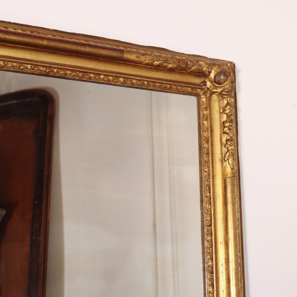 A large rectangular French antique mirror featuring a gold gilded frame with beaded moulding and carved corner details. View III
