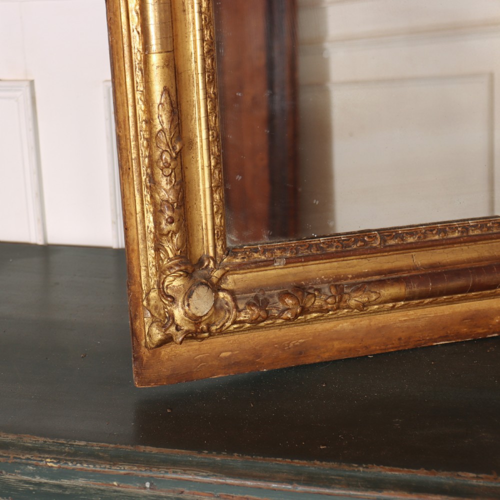 A large rectangular French antique mirror featuring a gold gilded frame with beaded moulding and carved corner details. View V