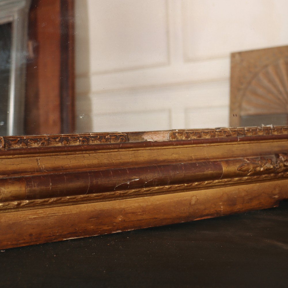 A large rectangular French antique mirror featuring a gold gilded frame with beaded moulding and carved corner details. View VI