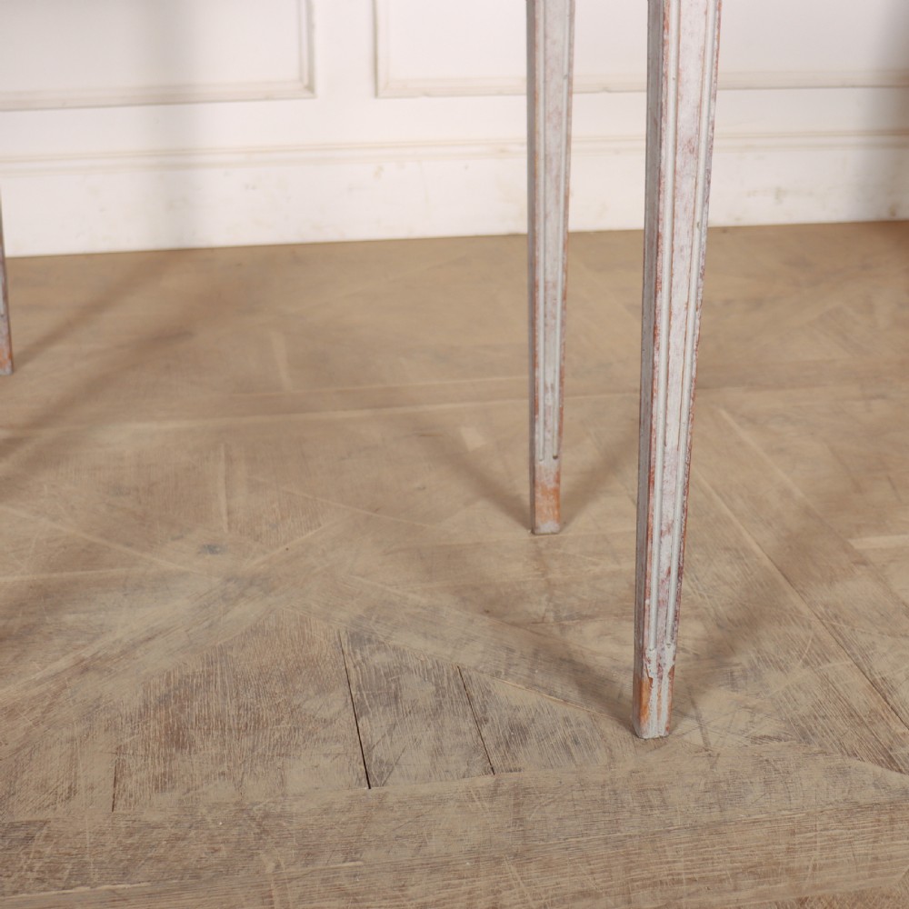 A pair of tall rectangular Swedish side tables with distressed pale grey painted finishes and slender tapered legs. View IV