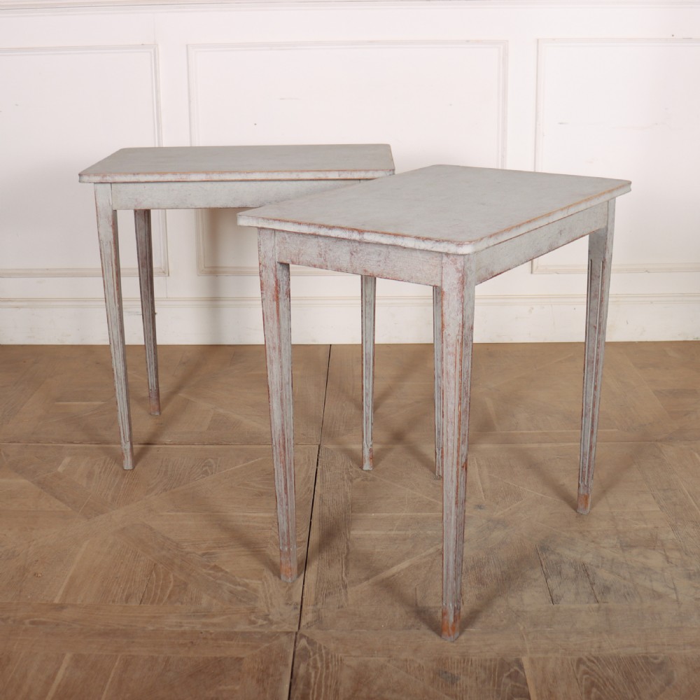 A pair of tall rectangular Swedish side tables with distressed pale grey painted finishes and slender tapered legs. View V