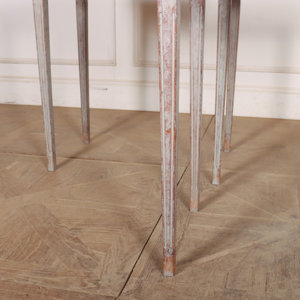 A pair of tall rectangular Swedish side tables with distressed pale grey painted finishes and slender tapered legs. View VI