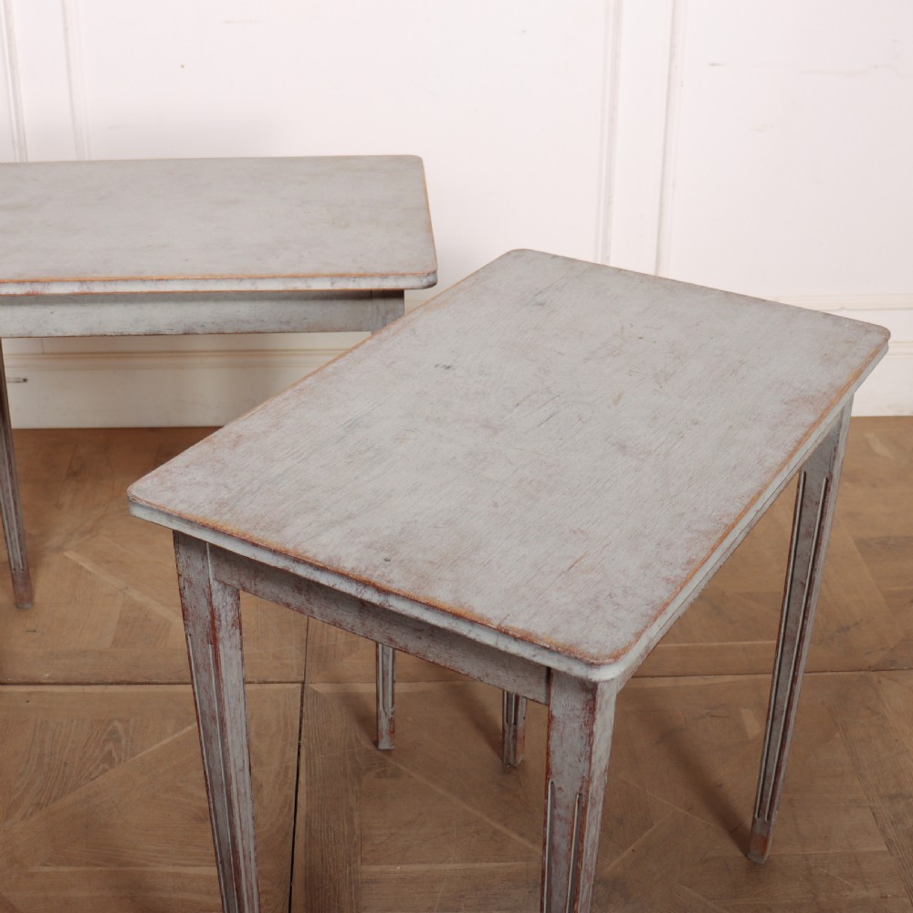 A pair of tall rectangular Swedish side tables with distressed pale grey painted finishes and slender tapered legs. View VIII