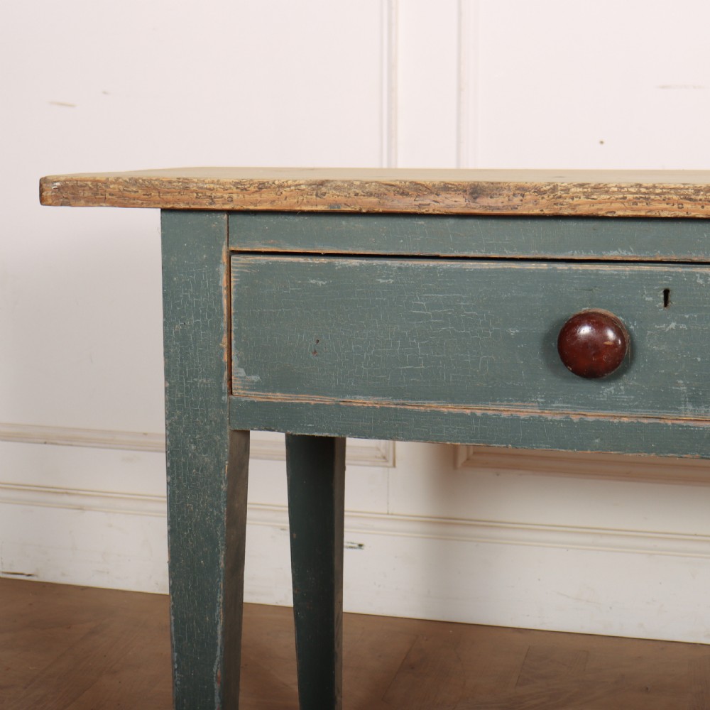 An antique Scottish console table featuring a muted green painted base with two drawers, dark wooden turned knobs, square tapered legs, and a natural pine top. View II