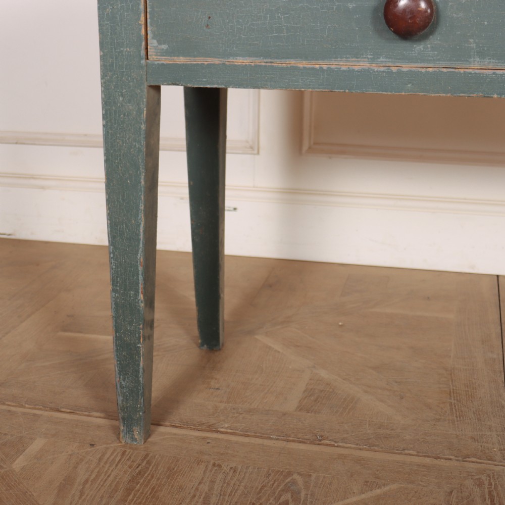 An antique Scottish console table featuring a muted green painted base with two drawers, dark wooden turned knobs, square tapered legs, and a natural pine top. View III