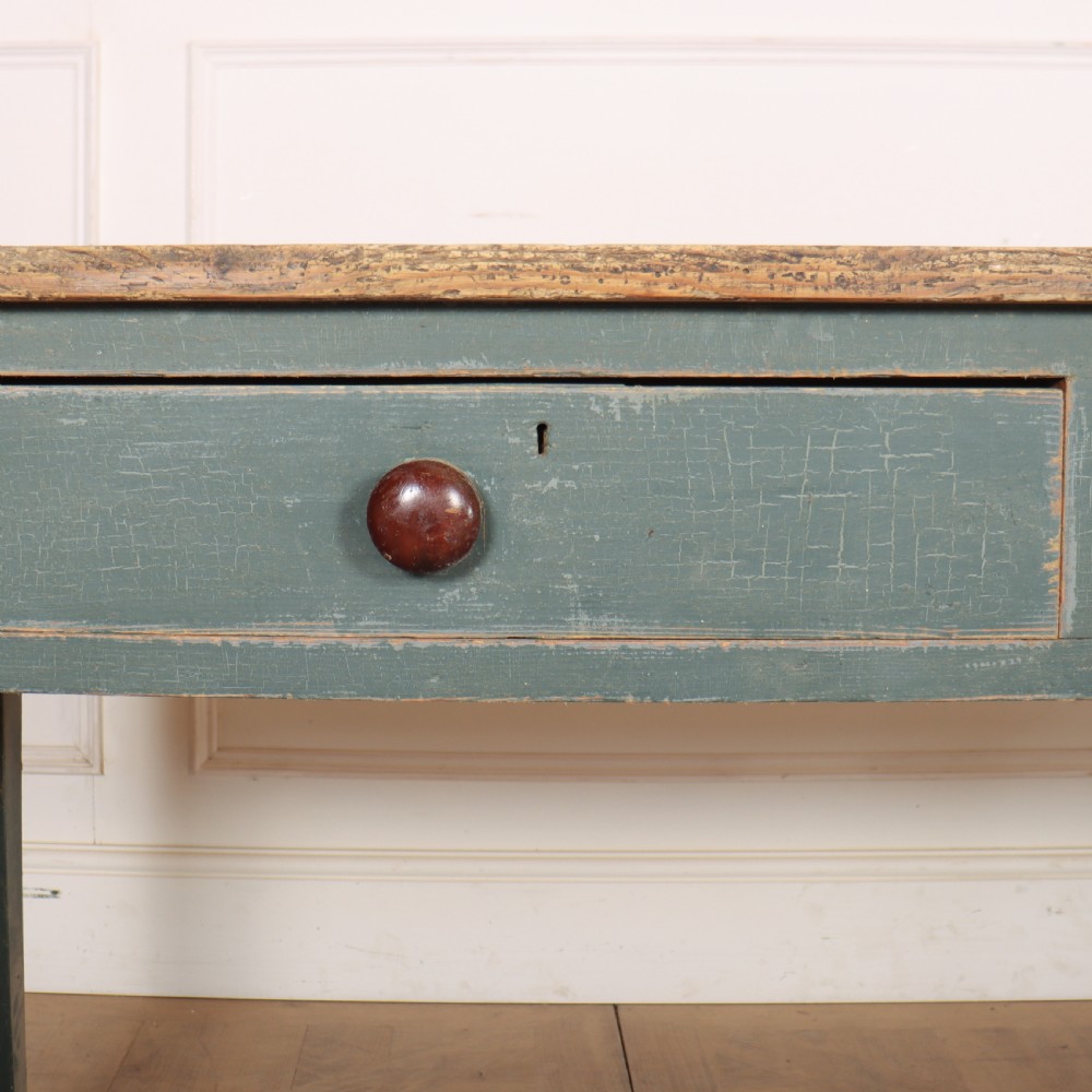 An antique Scottish console table featuring a muted green painted base with two drawers, dark wooden turned knobs, square tapered legs, and a natural pine top. View VI