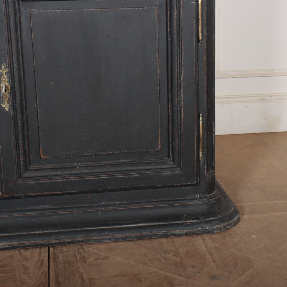 A two-piece black painted Dutch cabinet featuring arched glazed upper doors with wavy astragal bars, a green interior, and solid double doors below. View VIII