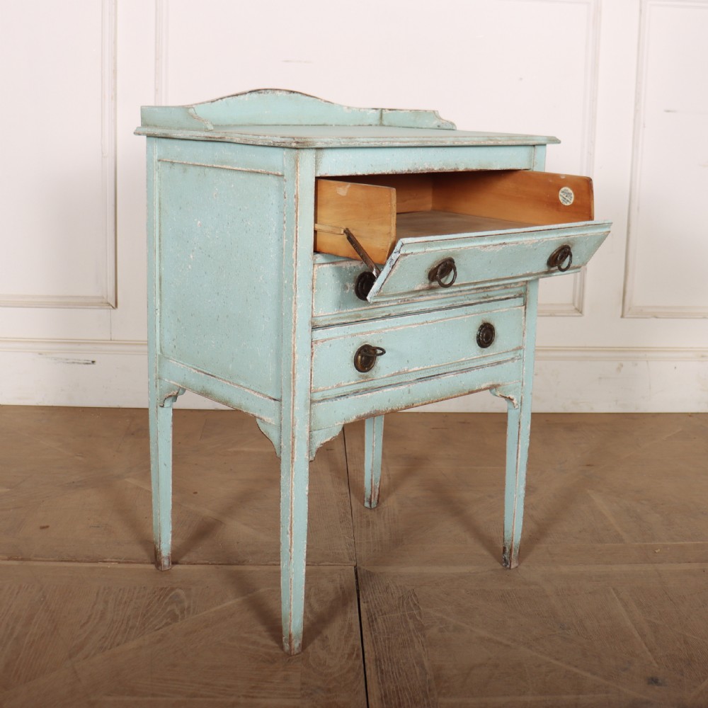 A pale blue painted three-drawer antique bedside cabinet featuring dark round knobs and a low gallery top. View IX