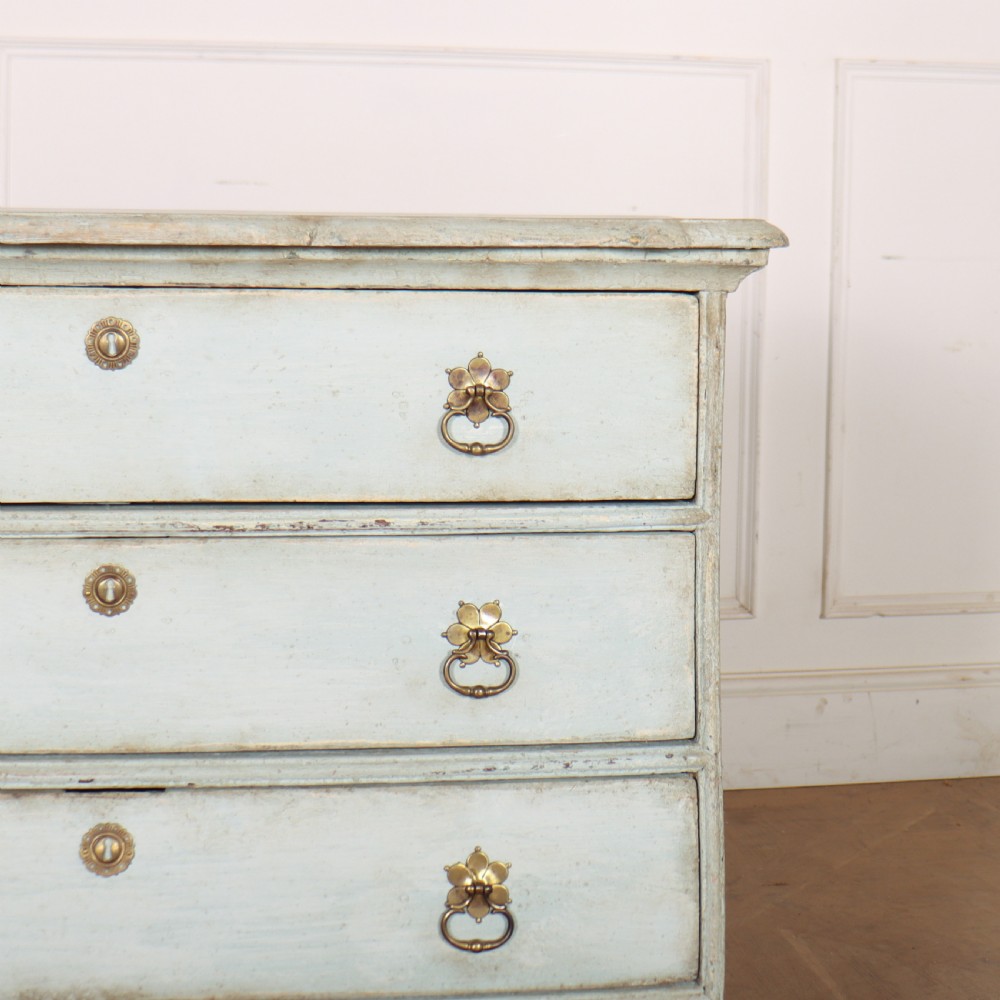 A nineteenth-century Dutch four-drawer commode featuring a distressed pale blue painted finish, brass rosette ring handles, and bracket feet. View III