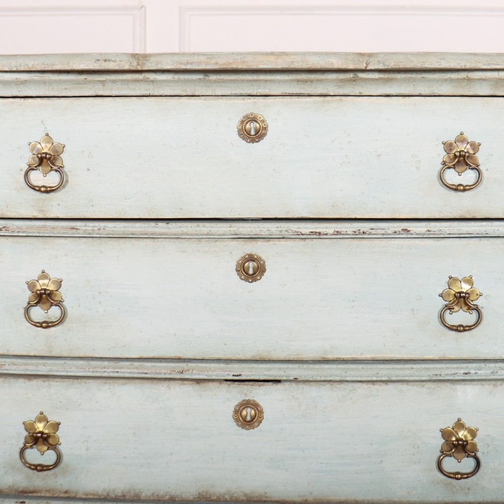 A nineteenth-century Dutch four-drawer commode featuring a distressed pale blue painted finish, brass rosette ring handles, and bracket feet. View VII