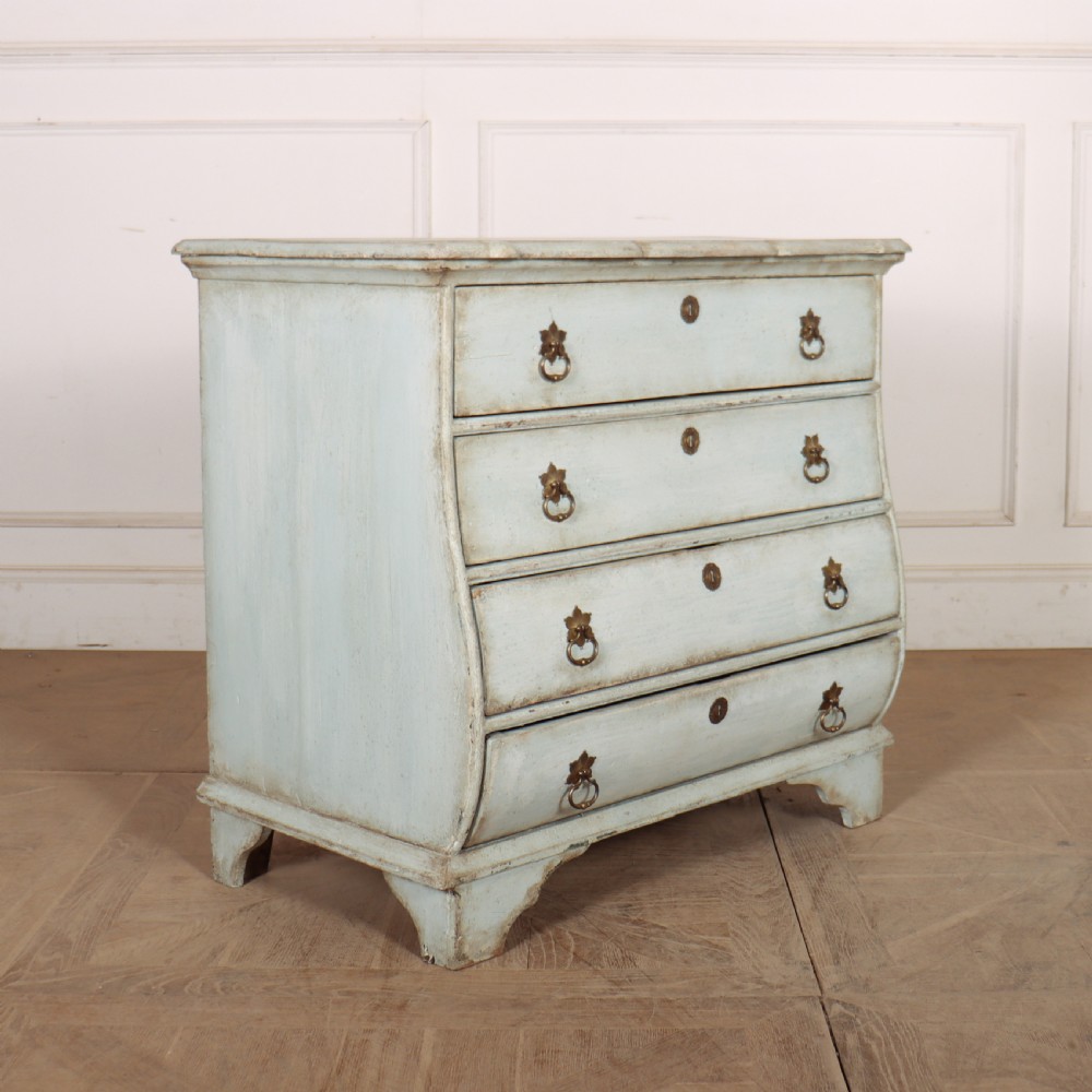 A nineteenth-century Dutch four-drawer commode featuring a distressed pale blue painted finish, brass rosette ring handles, and bracket feet. View VIII