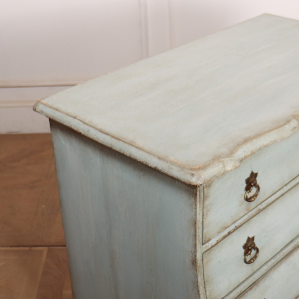 A nineteenth-century Dutch four-drawer commode featuring a distressed pale blue painted finish, brass rosette ring handles, and bracket feet. View IX