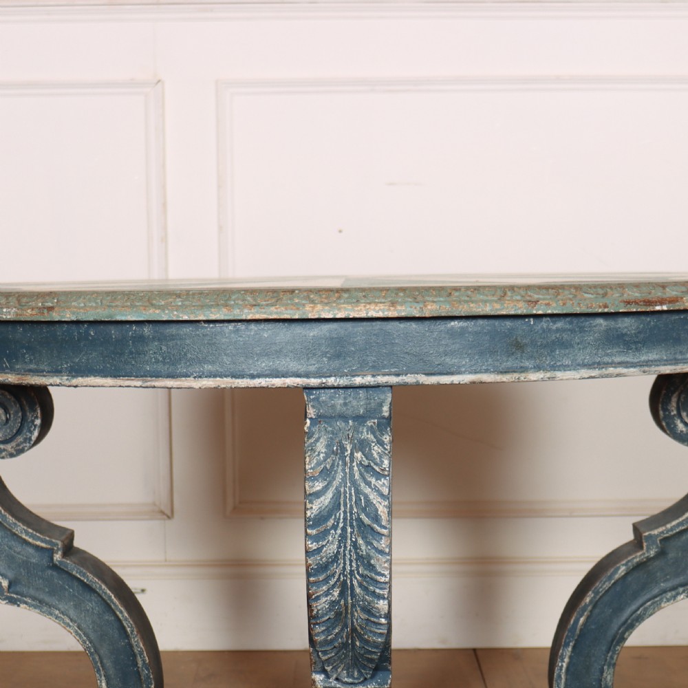 A round blue painted lamp table featuring a starburst pattern top, carved scroll legs, and an X-frame base. View IV