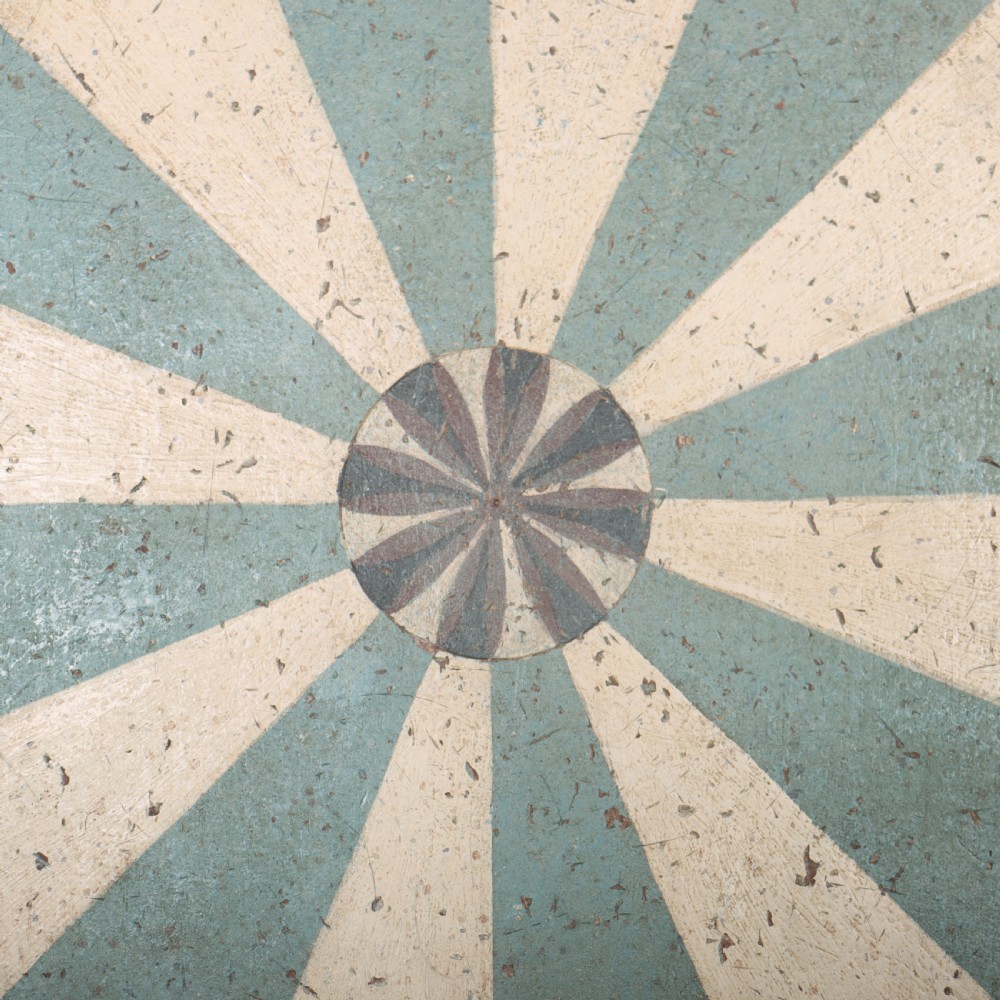 A round blue painted lamp table featuring a starburst pattern top, carved scroll legs, and an X-frame base. View XV