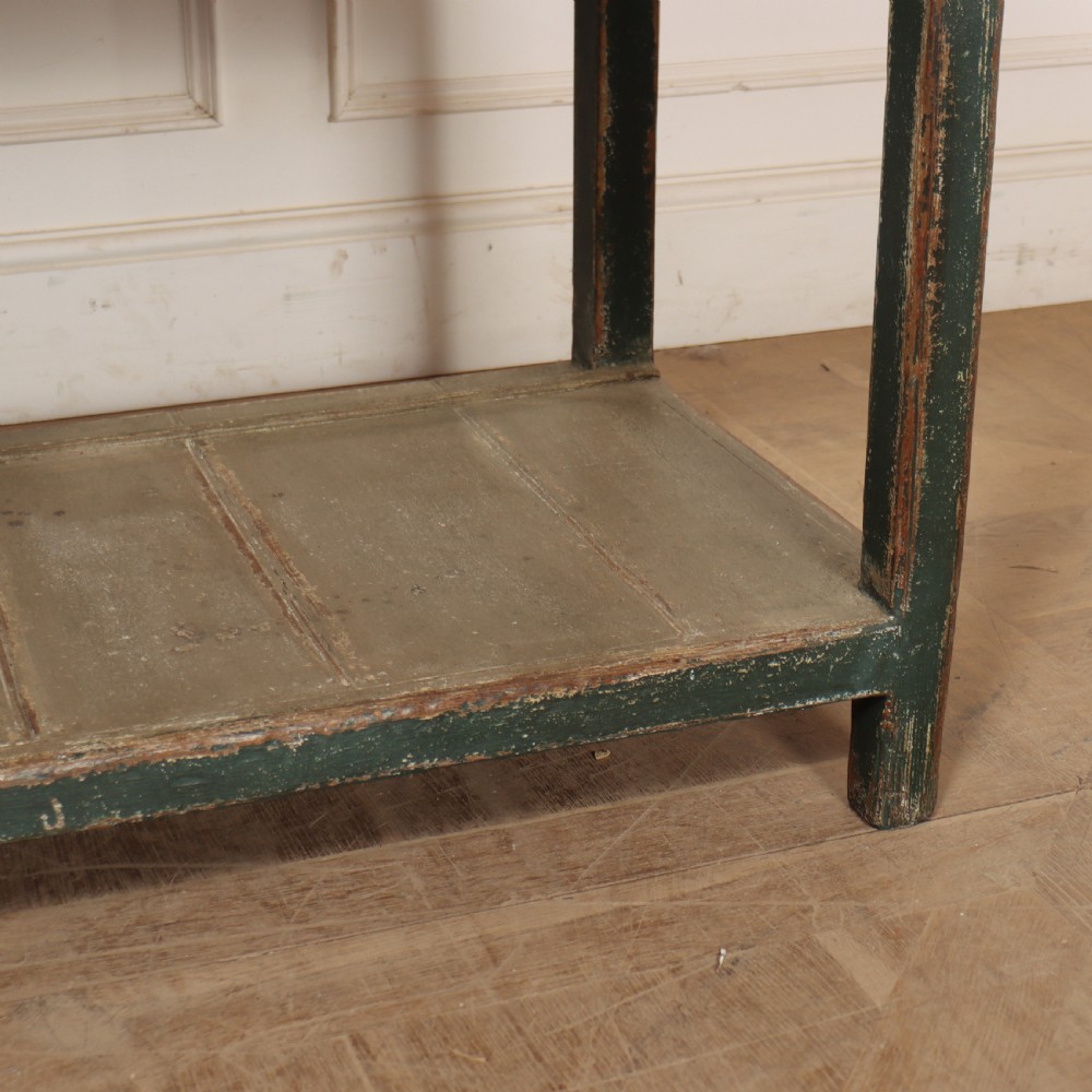 An antique dark green painted wooden pot board dresser featuring an upper three-tier plate rack with cup hooks above two drawers and an open bottom shelf. View XIII