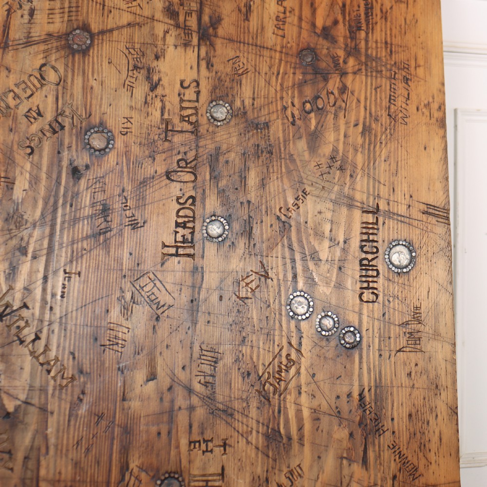 A low rectangular wooden coffee table featuring turned reeded legs and a surface decorated with carved typography and circular details. View IV