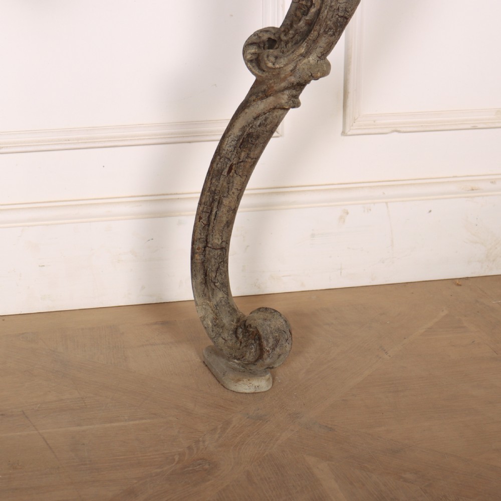 An Italian Rococo styled console table featuring heavily carved cabriole legs, a central apron cartouche motif, distressed grey paint finish, and a dark top. View VI