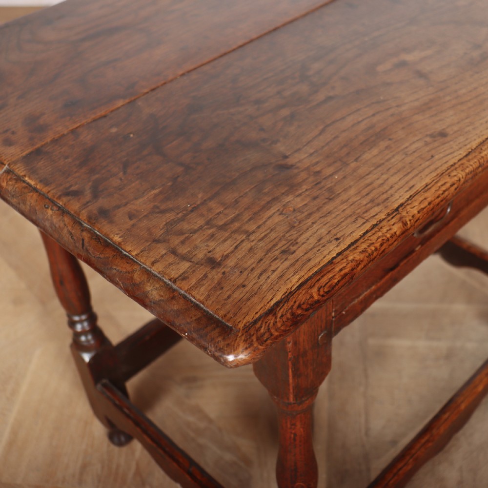 An antique English oak lamp table featuring a single drawer with brass handles, turned legs, and lower stretchers. View VIII
