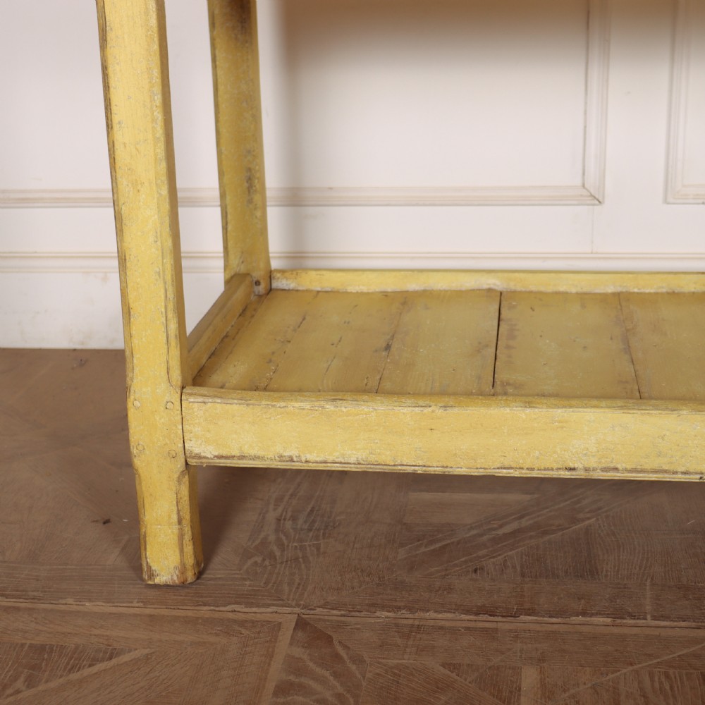 A long antique English painted wooden serving table featuring five drawers, a natural timber top, a distressed yellow base, and a low potboard shelf. View VI