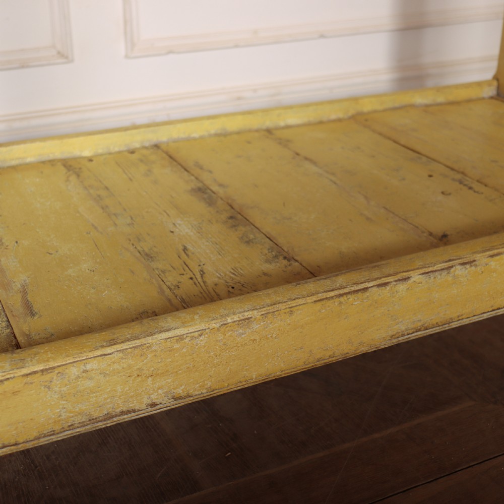 A long antique English painted wooden serving table featuring five drawers, a natural timber top, a distressed yellow base, and a low potboard shelf. View XIV