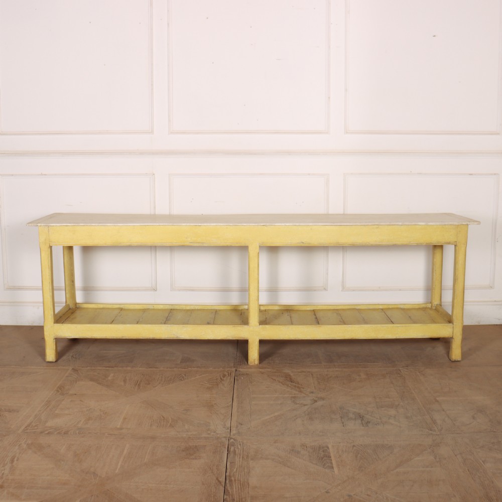A long antique English painted wooden serving table featuring five drawers, a natural timber top, a distressed yellow base, and a low potboard shelf. View XIX