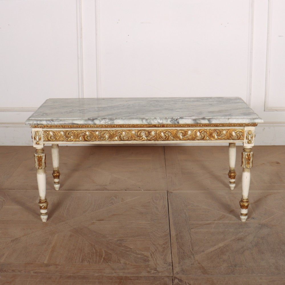 A rectangular French Louis XVI style low coffee table featuring a grey and white veined marble top set on a carved giltwood and painted frame with fluted tapered legs. View VII