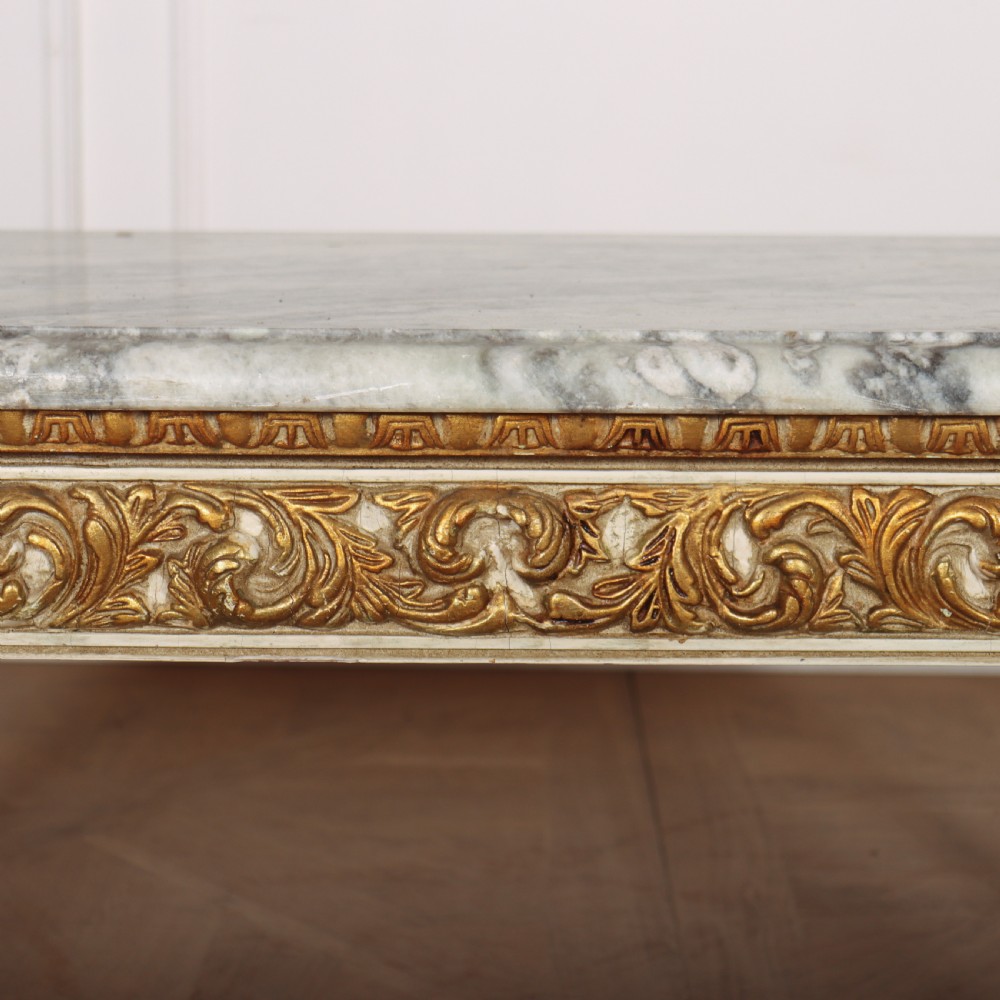 A rectangular French Louis XVI style low coffee table featuring a grey and white veined marble top set on a carved giltwood and painted frame with fluted tapered legs. View X