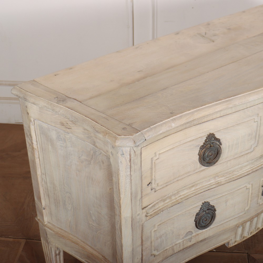 An off-white painted Italian serpentine front commode with two long drawers, panel moulding, metal handles, and square tapered legs. View X