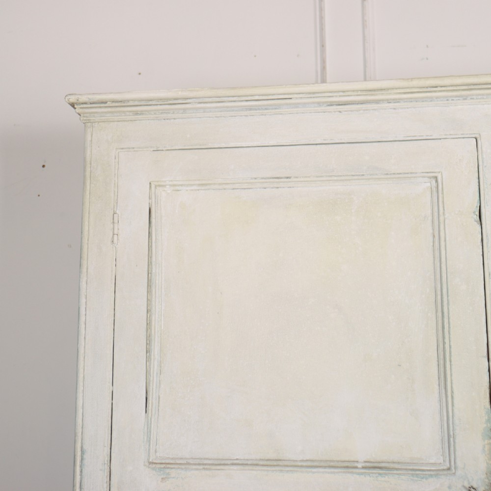 An 18th-century painted housekeepers cupboard featuring fielded panel upper doors, three central drawers, and lower storage cabinets on bracket feet. View II
