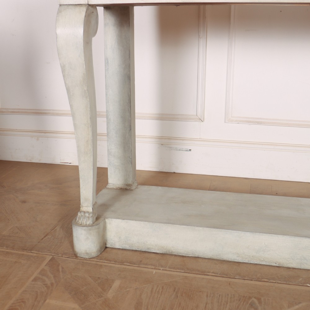A pale grey painted French console table featuring a light marble top slab, cabriole front legs, and a bottom plinth shelf. View IV