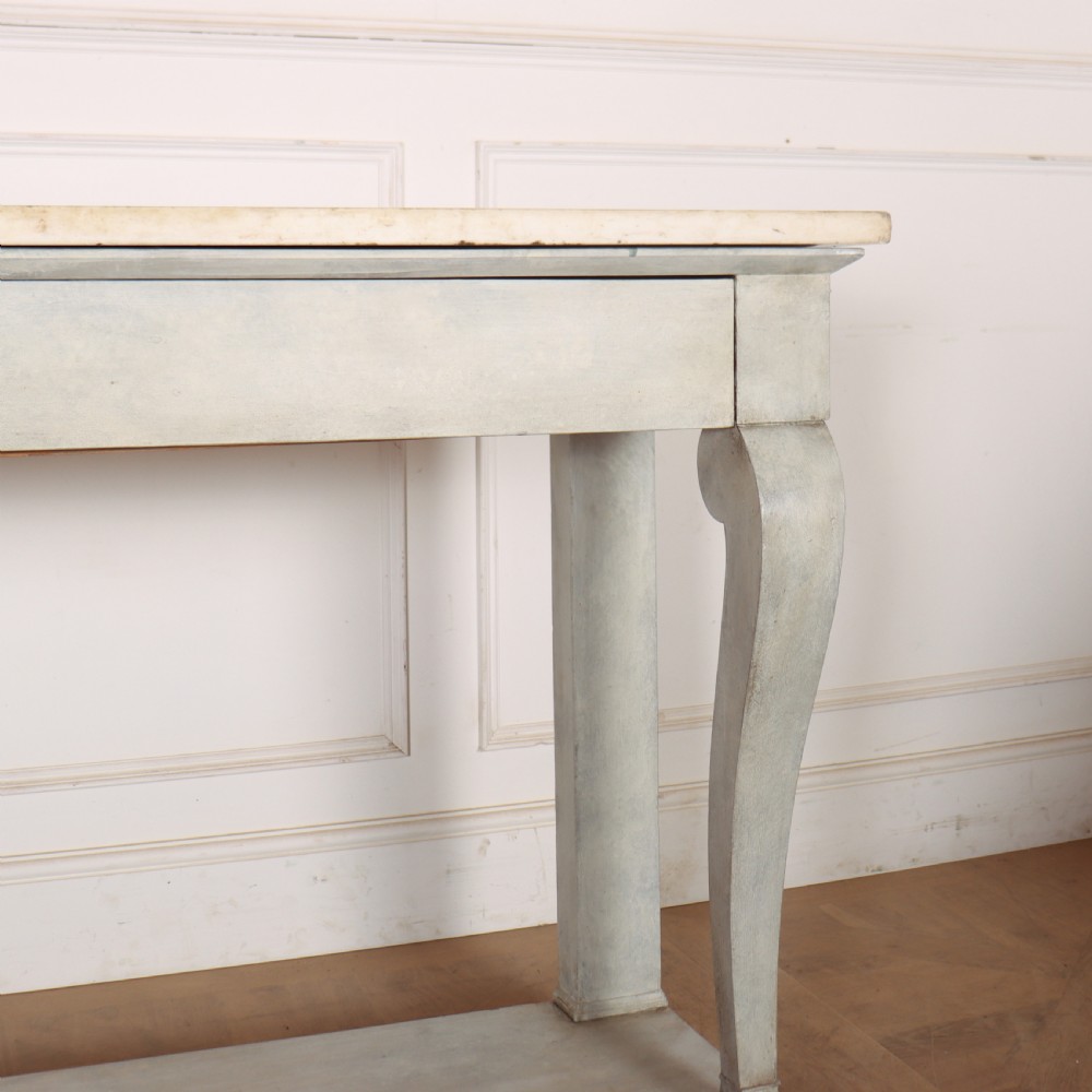 A pale grey painted French console table featuring a light marble top slab, cabriole front legs, and a bottom plinth shelf. View VI