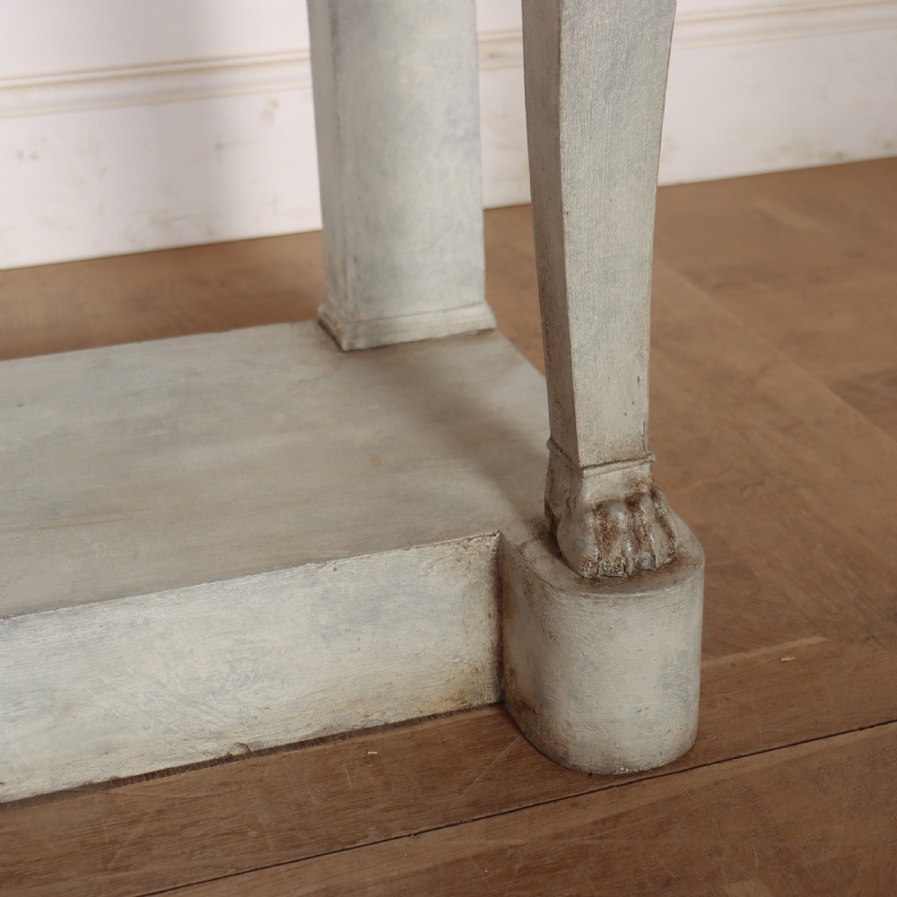 A pale grey painted French console table featuring a light marble top slab, cabriole front legs, and a bottom plinth shelf. View VII