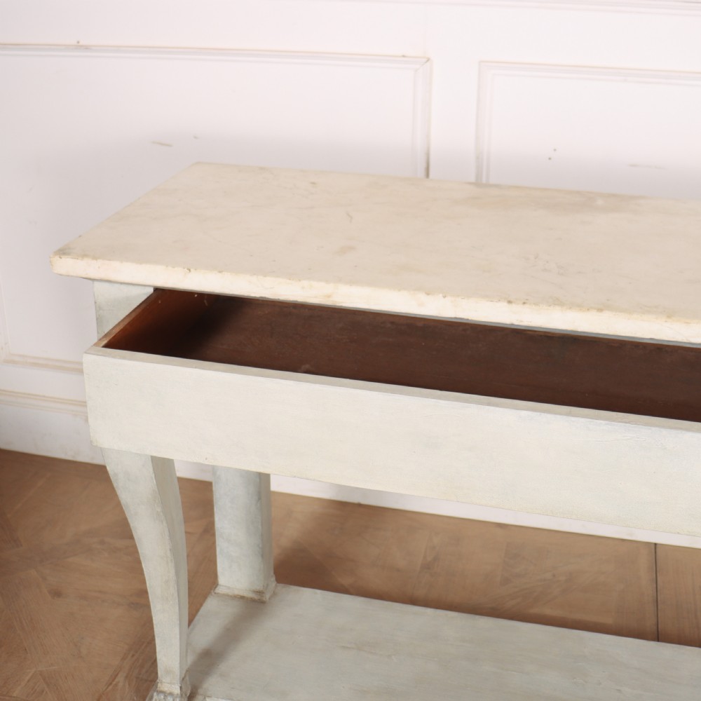 A pale grey painted French console table featuring a light marble top slab, cabriole front legs, and a bottom plinth shelf. View VIII