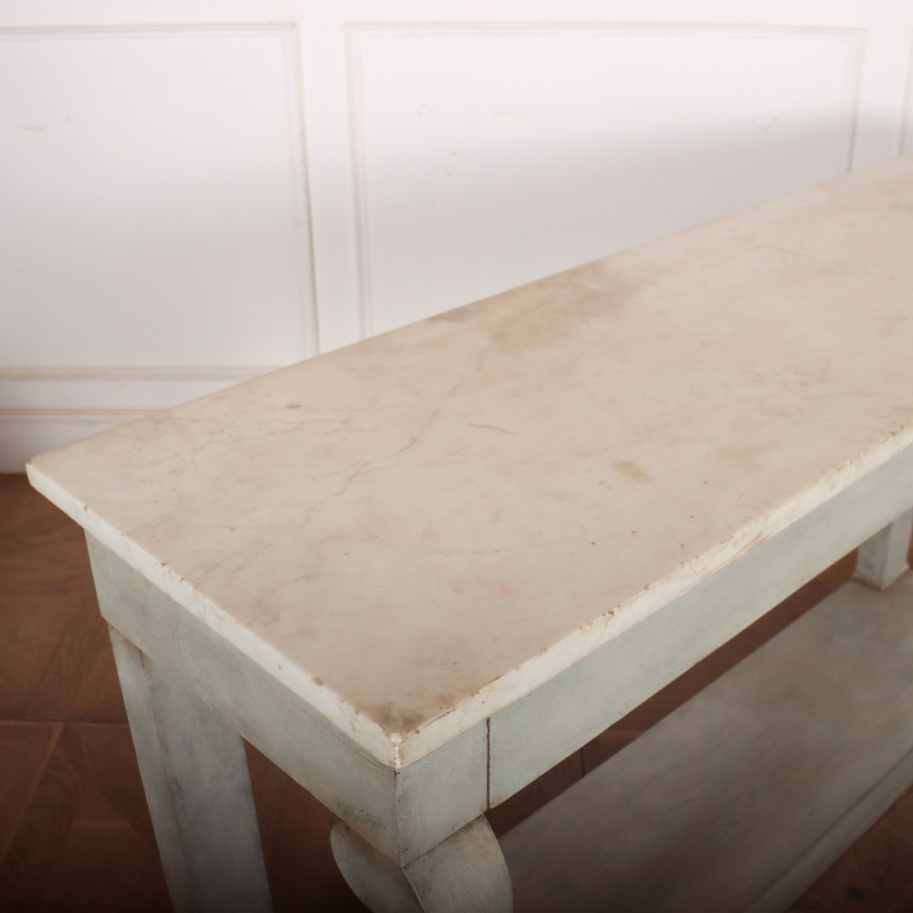 A pale grey painted French console table featuring a light marble top slab, cabriole front legs, and a bottom plinth shelf. View IX