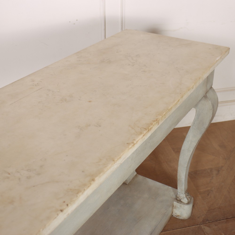 A pale grey painted French console table featuring a light marble top slab, cabriole front legs, and a bottom plinth shelf. View X