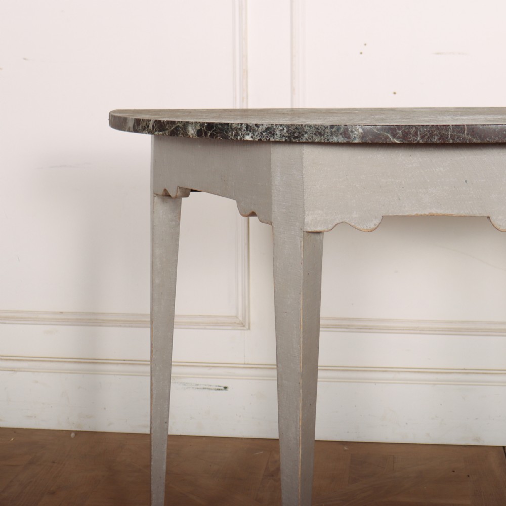 A 19th-century demilune console table featuring a grey marble top and a light grey painted frame supported by four tapered square legs. View II