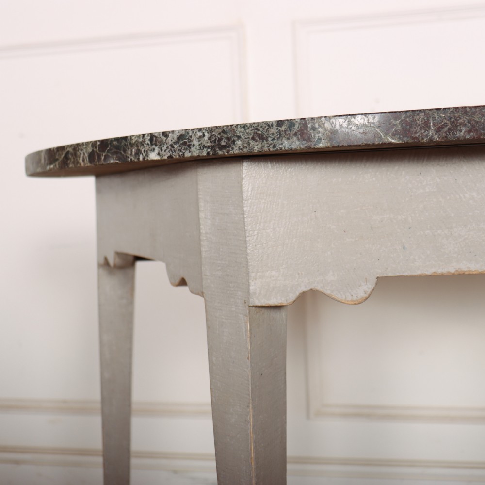 A 19th-century demilune console table featuring a grey marble top and a light grey painted frame supported by four tapered square legs. View IV