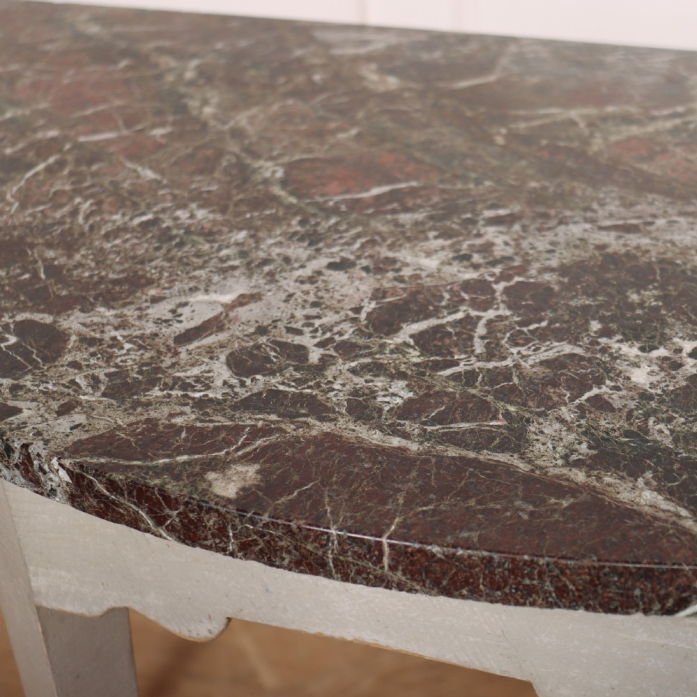 A 19th-century demilune console table featuring a grey marble top and a light grey painted frame supported by four tapered square legs. View VII