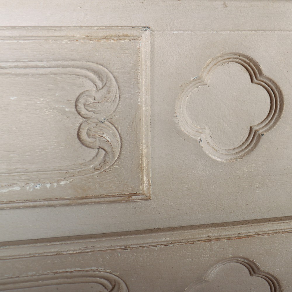 A pair of light cream painted French commodes featuring three drawers each, detailed with brass handles, carved apron shells, and cabriole legs. View VII