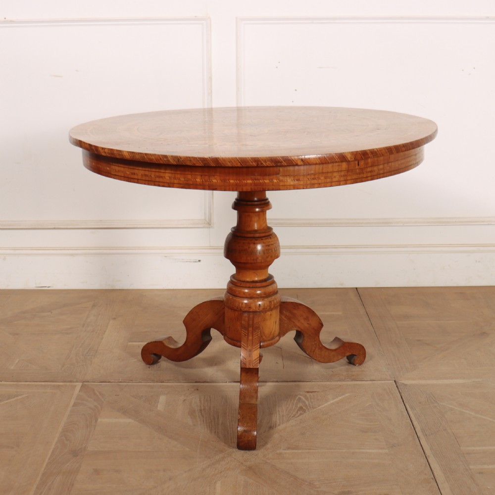 A circular 19th-century Swedish birch centre table featuring a turned central pedestal column resting on curved feet.