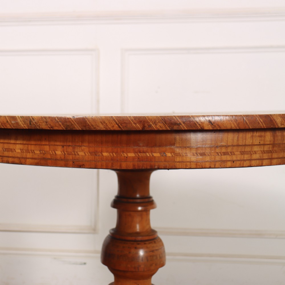 A circular 19th-century Swedish birch centre table featuring a turned central pedestal column resting on curved feet. View VI