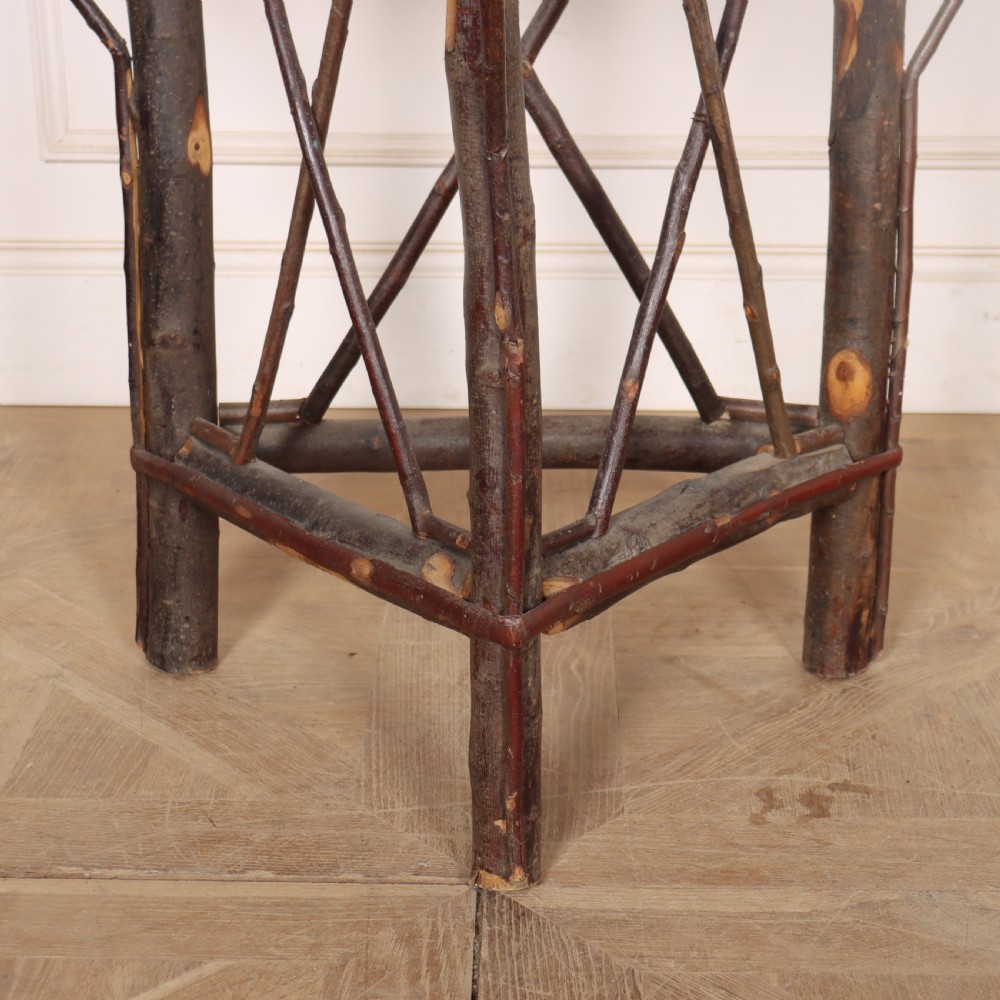 A demilune console table crafted from unpeeled rustic tree branches with a patterned teal painted top. View III